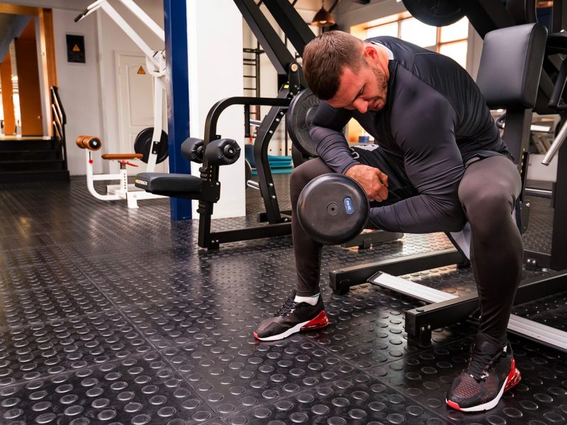 male-athlete-doing-biceps-exercise-with-dumbbells-X32HPD6-min.jpg
